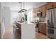 Bright kitchen features a large island with seating, stainless steel appliances, and modern light fixtures at 5604 Kingspan Dr, Charlotte, NC 28217