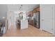 Open kitchen with a large island, stainless steel appliances, and hardwood floors at 5604 Kingspan Dr, Charlotte, NC 28217