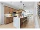 Open-concept kitchen with a large island, stainless steel appliances, and modern pendant lighting at 5604 Kingspan Dr, Charlotte, NC 28217