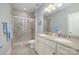 Well-lit bathroom with double vanity, granite countertops, and glass-enclosed shower at 5706 Sardis Hall Ct, Charlotte, NC 28270