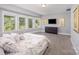 Carpeted bedroom with lots of natural light and a TV at 5706 Sardis Hall Ct, Charlotte, NC 28270