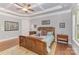 Spacious bedroom with hardwood floors, tray ceilings, natural light, and decorative furnishings at 5706 Sardis Hall Ct, Charlotte, NC 28270