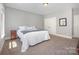 Bedroom featuring neutral carpet, soft natural light, and ample closet space at 5706 Sardis Hall Ct, Charlotte, NC 28270