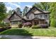 Stone two-story home featuring manicured landscaping and a covered front porch at 5706 Sardis Hall Ct, Charlotte, NC 28270