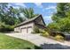 Beautiful brick home with a well-manicured lawn, lush landscaping, and a three-car garage at 5706 Sardis Hall Ct, Charlotte, NC 28270