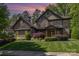 Stone two-story home featuring manicured landscaping and a covered front porch at 5706 Sardis Hall Ct, Charlotte, NC 28270
