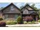 Stone two-story home featuring beautiful landscaping and a covered front porch at 5706 Sardis Hall Ct, Charlotte, NC 28270