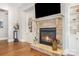 Living room fireplace with stone surround and built in storage and shelving at 5706 Sardis Hall Ct, Charlotte, NC 28270