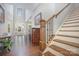 Inviting foyer with hardwood floors, staircase, and lots of natural light at 5706 Sardis Hall Ct, Charlotte, NC 28270