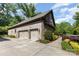 Brick home with a spacious three-car garage, lush landscaping, and paved driveway at 5706 Sardis Hall Ct, Charlotte, NC 28270