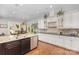 Bright kitchen features a center island, stainless steel appliances, and white cabinetry at 5706 Sardis Hall Ct, Charlotte, NC 28270