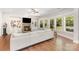 Comfortable living room with a fireplace, built-in shelving, large windows, and hardwood floors at 5706 Sardis Hall Ct, Charlotte, NC 28270