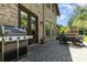 Outdoor patio featuring a grill, dining area, and brick-paved flooring at 5706 Sardis Hall Ct, Charlotte, NC 28270