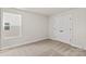 Cozy bedroom with neutral carpet, natural light, and a double door closet at 5716 Skinny Dr, Charlotte, NC 28215