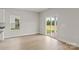 Bright dining area with sliding glass doors leading to the backyard and wood-look flooring at 5716 Skinny Dr, Charlotte, NC 28215