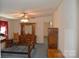 Primary bedroom features wood furniture, blue carpet, and natural lighting at 648 Dobson Farm Rd, Statesville, NC 28625