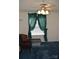 Bedroom with a fan, chair, window with green curtains, and blue carpet at 648 Dobson Farm Rd, Statesville, NC 28625