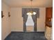 Bright dining area features blue carpet, chandelier, and neutral wall color at 648 Dobson Farm Rd, Statesville, NC 28625