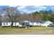 Charming single-story home with white siding, dark shutters, well-manicured lawn and mature landscaping at 648 Dobson Farm Rd, Statesville, NC 28625