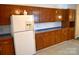 Traditional kitchen features wood cabinets, white appliances, and blue tiled countertops at 648 Dobson Farm Rd, Statesville, NC 28625