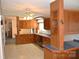 Spacious kitchen featuring wood cabinetry, blue tile countertops, and a ceiling fan at 648 Dobson Farm Rd, Statesville, NC 28625