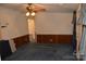 Inviting living room with a ceiling fan, carpeted floors, and wood paneling at 648 Dobson Farm Rd, Statesville, NC 28625