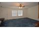 Inviting living room with a ceiling fan, carpeted floors, and natural light at 648 Dobson Farm Rd, Statesville, NC 28625