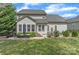Spacious backyard featuring a dining set, lush lawn and multiple windows with ample sunlight at 7215 Meyer Rd, Fort Mill, SC 29715