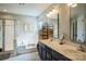 Well-lit bathroom featuring double vanity, soaking tub, and a separate glass enclosed shower at 7215 Meyer Rd, Fort Mill, SC 29715