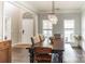 Bright dining room featuring hardwood floors, modern lighting, and ample seating at 7215 Meyer Rd, Fort Mill, SC 29715