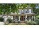 Charming home featuring a lovely front porch, manicured landscaping, and classic black shutters at 7215 Meyer Rd, Fort Mill, SC 29715