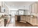 Well-equipped kitchen with stone countertops, white cabinets, stainless appliances and hardwood floors at 7215 Meyer Rd, Fort Mill, SC 29715