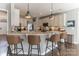 Open kitchen with stone countertops, white cabinets, stainless appliances and hardwood floors at 7215 Meyer Rd, Fort Mill, SC 29715