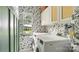 Cozy laundry room with modern appliances, custom storage and designer wallpaper at 7215 Meyer Rd, Fort Mill, SC 29715