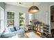 Bright playroom featuring a comfortable lounge, shelving and large windows overlooking the back yard at 7215 Meyer Rd, Fort Mill, SC 29715
