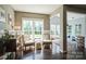 Sunlit sitting room features hardwood floors, classic moulding, and a decorative vintage cabinet at 7215 Meyer Rd, Fort Mill, SC 29715