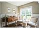 Sunlit sitting room features hardwood floors, classic moulding, and a decorative vintage cabinet at 7215 Meyer Rd, Fort Mill, SC 29715