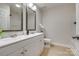 This bathroom has double sinks with white cabinetry and tile floors at 722 Sandy Green Ct, Fort Mill, SC 29715
