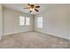 Bedroom with neutral walls, carpeted floors, two windows, and a ceiling fan at 722 Sandy Green Ct, Fort Mill, SC 29715