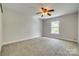 This carpeted bedroom has a window letting in natural light and neutral paint at 722 Sandy Green Ct, Fort Mill, SC 29715