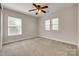 Bedroom with two windows allowing for natural light, neutral walls, and carpeted floors at 722 Sandy Green Ct, Fort Mill, SC 29715