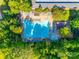 Aerial view of a large community pool surrounded by lounge chairs and shaded areas, nestled within mature trees at 722 Sandy Green Ct, Fort Mill, SC 29715