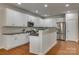 This is a kitchen with granite countertops, stainless steel appliances and white cabinets at 722 Sandy Green Ct, Fort Mill, SC 29715