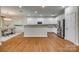 Modern kitchen featuring white cabinets, stainless steel appliances, and hardwood floors at 722 Sandy Green Ct, Fort Mill, SC 29715