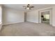 Spacious living room with neutral walls, plush carpet, and a ceiling fan for comfort at 722 Sandy Green Ct, Fort Mill, SC 29715