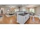 The living room flows from the kitchen, with hardwood floors, lots of natural light and modern furniture at 722 Sandy Green Ct, Fort Mill, SC 29715