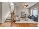 Living room area with two blue upholstered chairs, a loveseat, hardwood floors and a staircase at 722 Sandy Green Ct, Fort Mill, SC 29715