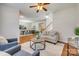 Bright living room with hardwood floors, stairs, and open floor plan to the dining area at 722 Sandy Green Ct, Fort Mill, SC 29715