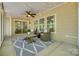 The airy sunroom features an outdoor view, string lights, and a fan at 722 Sandy Green Ct, Fort Mill, SC 29715