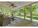 This sunroom features large windows, and an area rug for seating at 722 Sandy Green Ct, Fort Mill, SC 29715